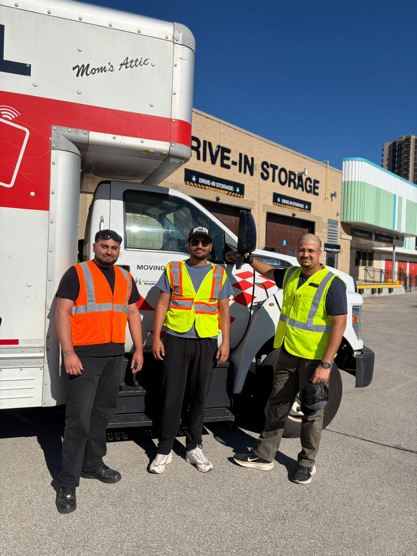 KG Elite Moving crew beside a moving truck at a London Ontario storage facility